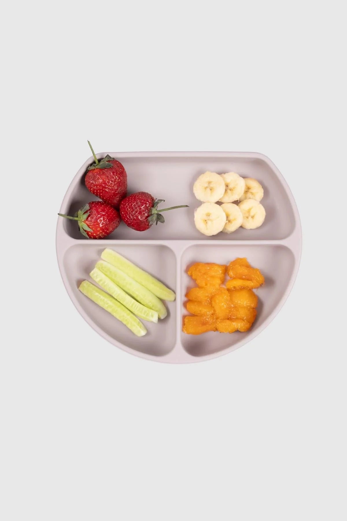 3 compartment baby feeding plate with lid in pink, holding strawberries, bananas, cucumbers, and sweet potato puree.
