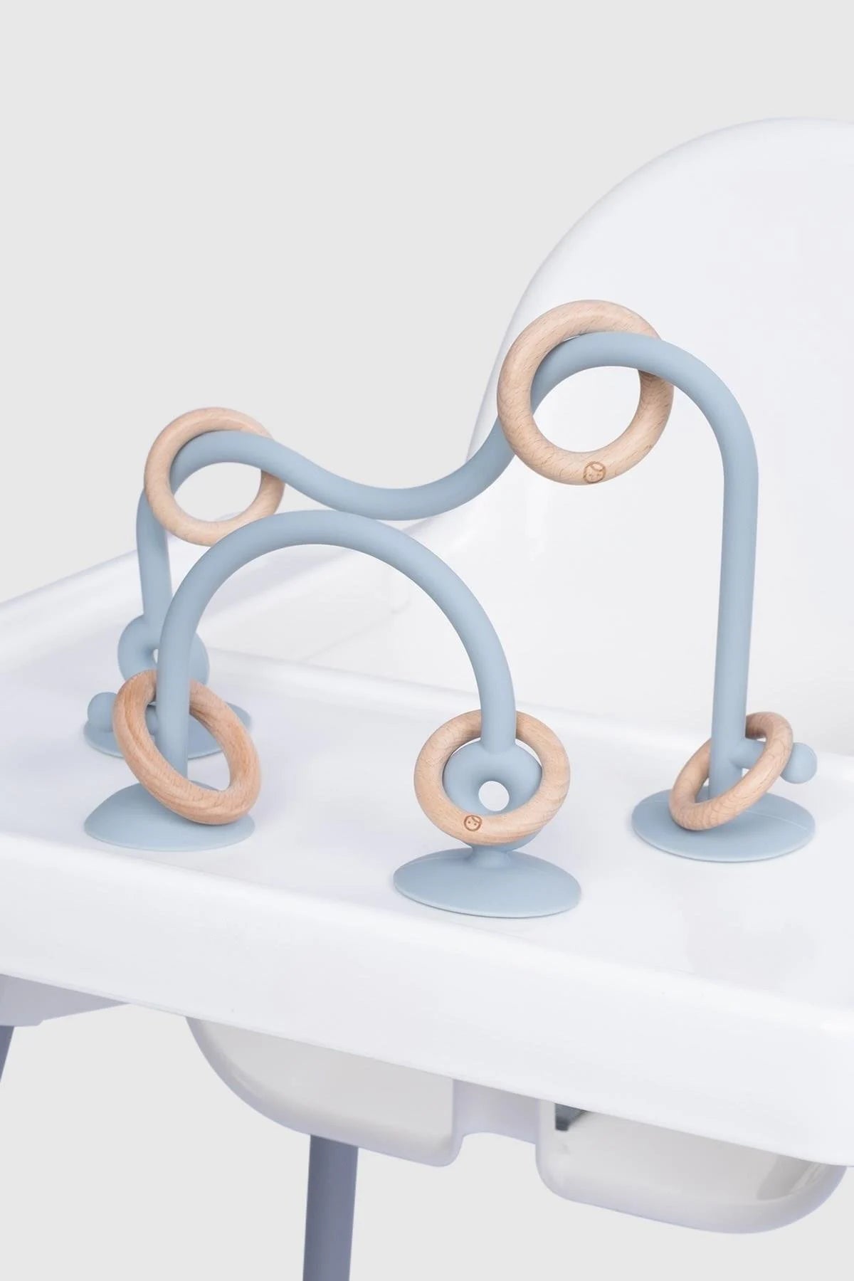 Blue silicone educational high chair toy with wooden rings, designed for baby and toddler playtime.