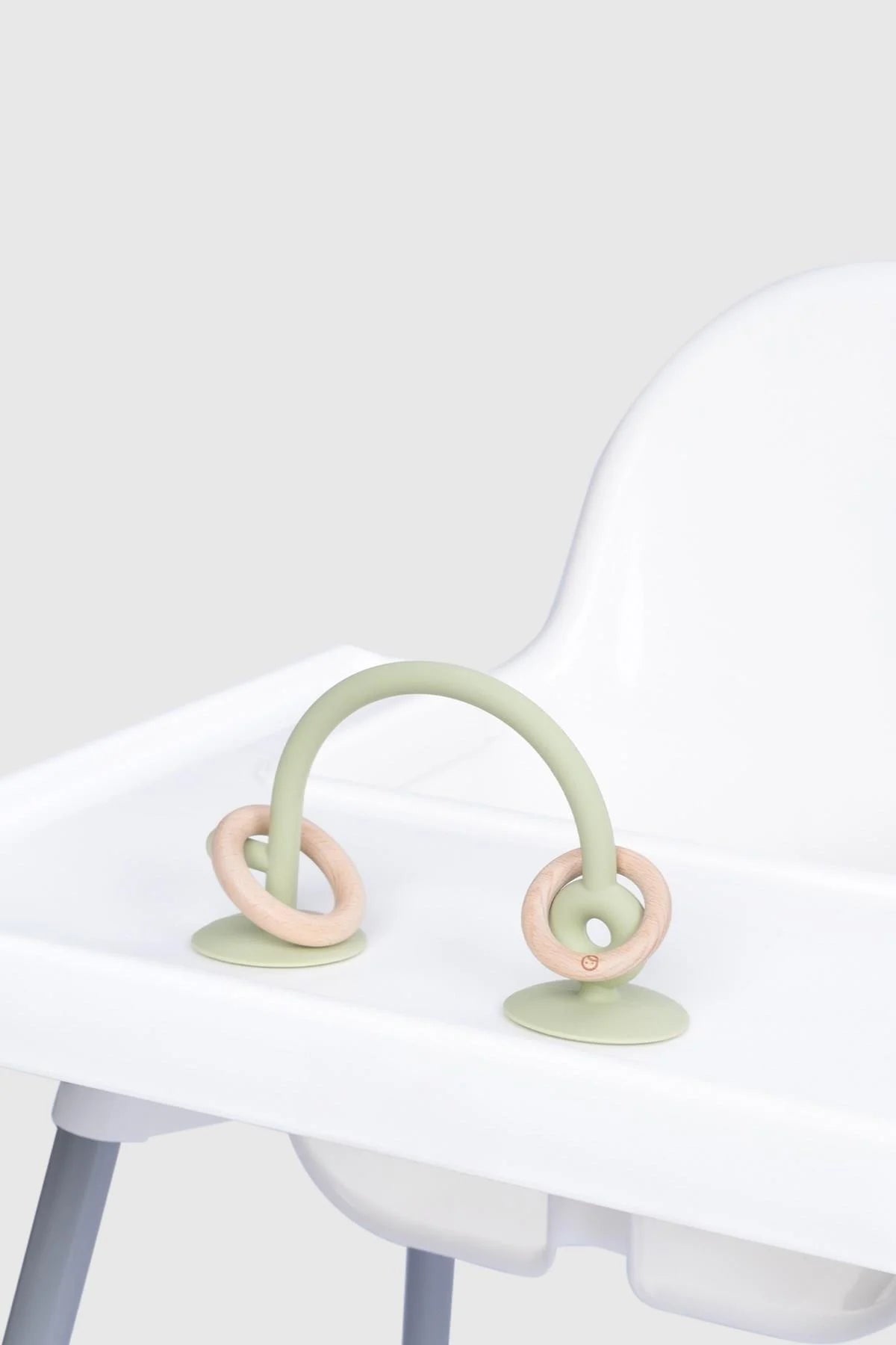 Silicone educational high chair toy in green with suction base for baby playtime, promoting learning and fun.