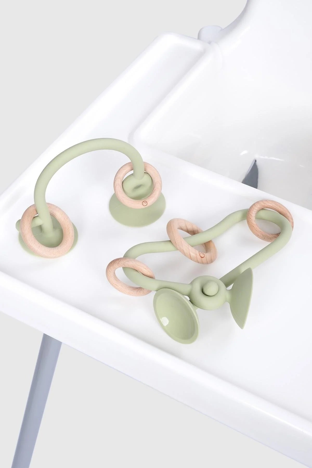 Silicone educational high chair toy in green and bamboo, designed for baby and toddler playtime activities.