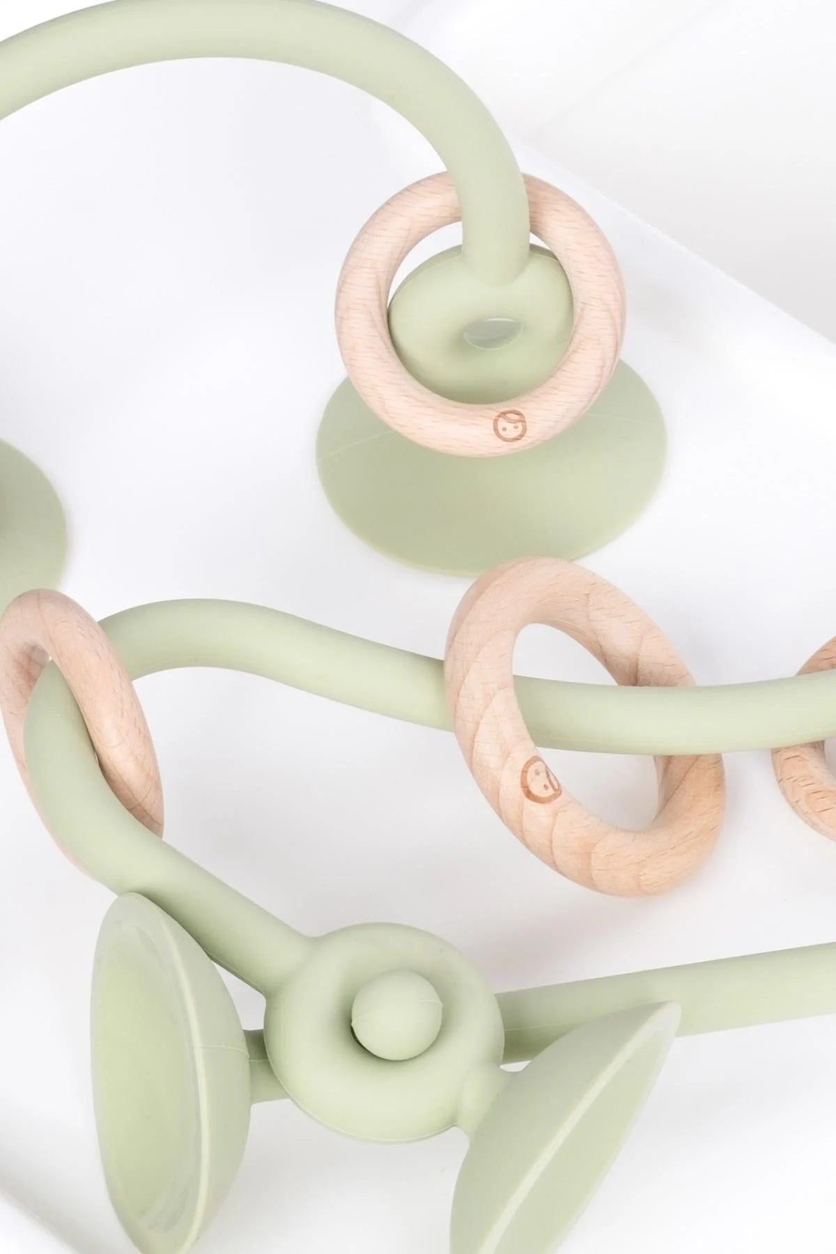 Little Gusto silicone educational high chair toy in green with wood accents for baby's playtime and learning.