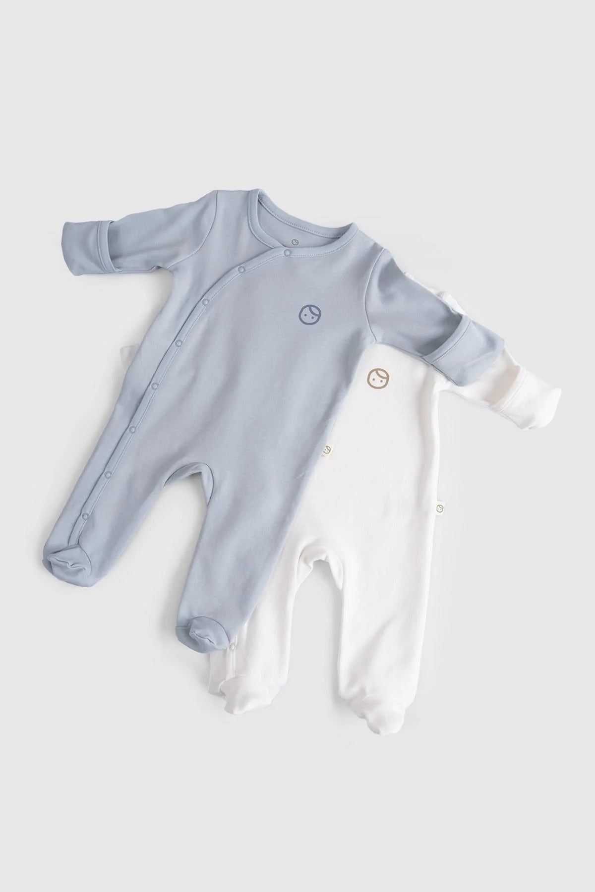 Blue and white organic cotton baby sleepsuits in a 2-pack, soft, breathable, and hypoallergenic.