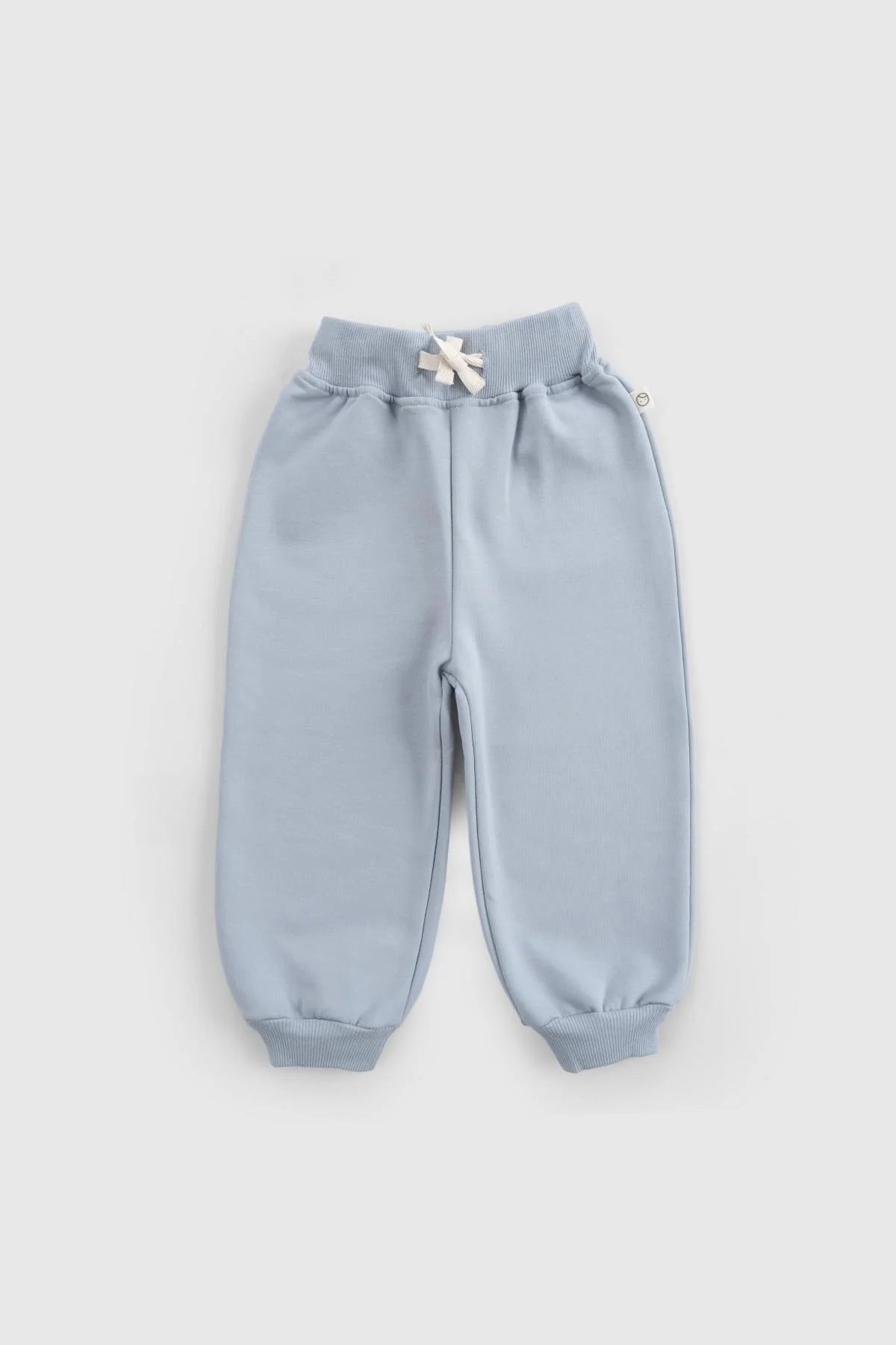 Soft blue cotton baby pants with ribbed cuffs and drawstring waistband, perfect for comfort and style.