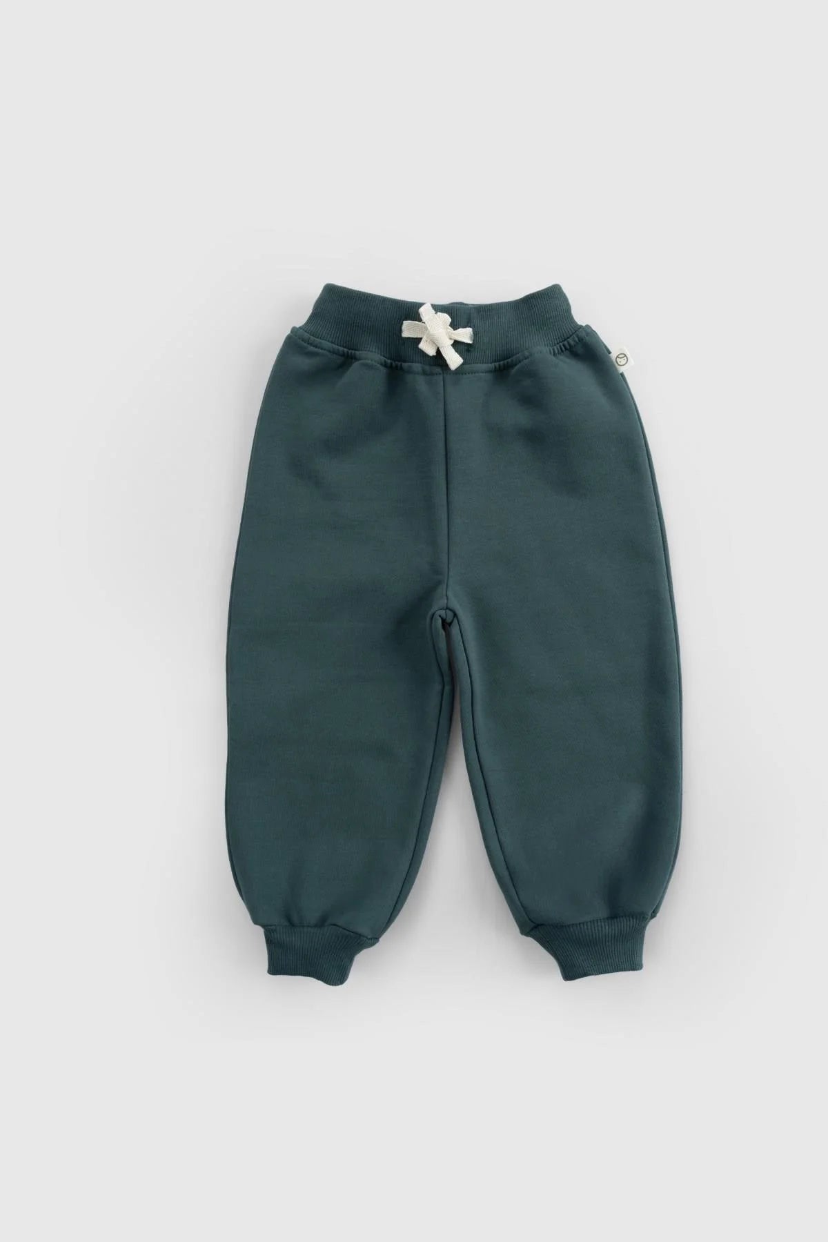 Organic cotton baby tracksuit pants in dark green, featuring a ribbed waistband and drawstring for comfort and style.