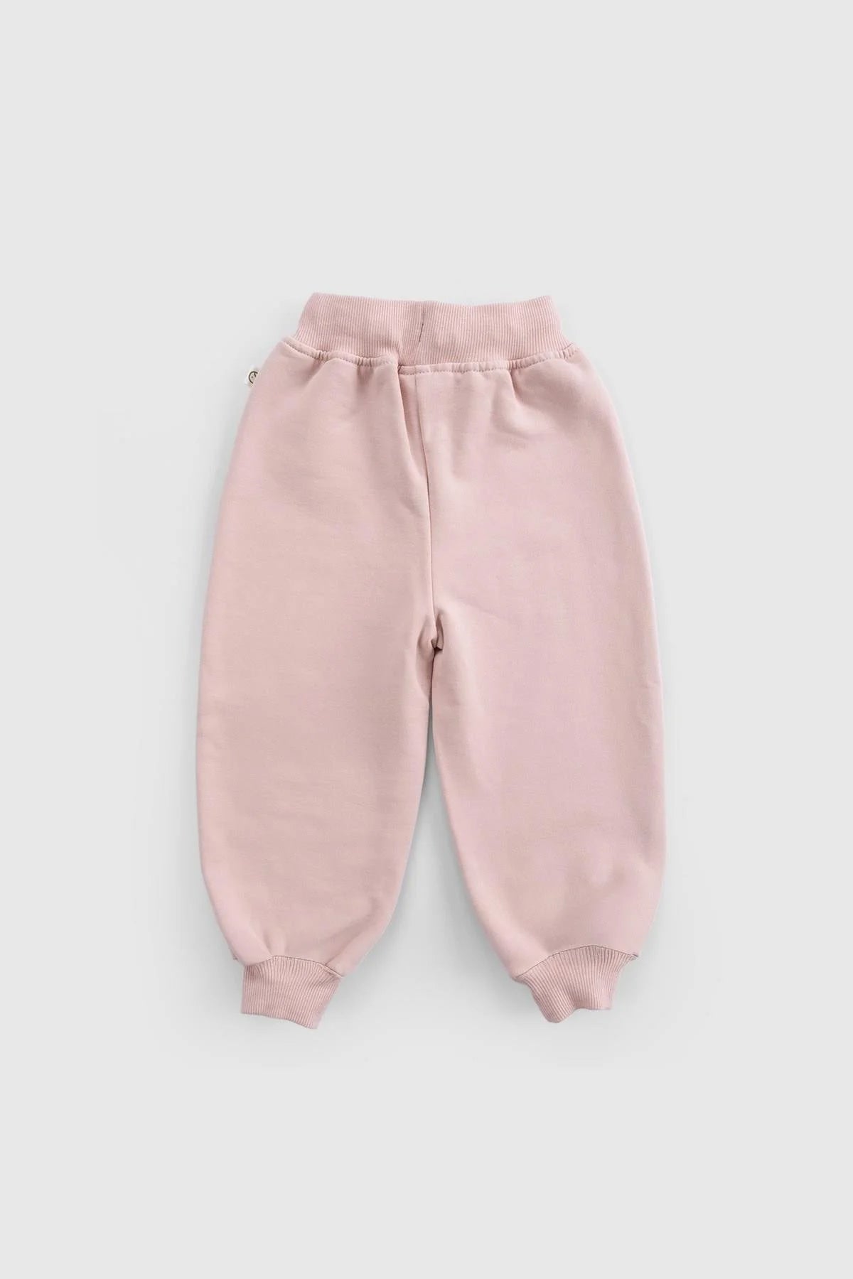 Soft pink organic cotton baby pants with ribbed cuffs for comfort and warmth.