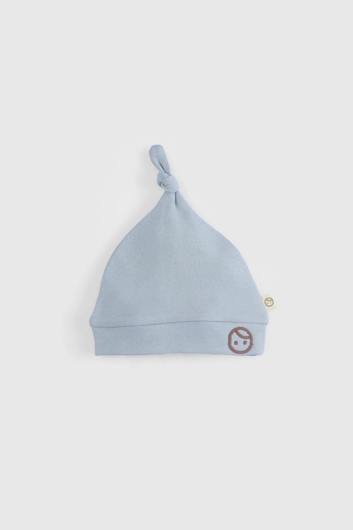 Light blue organic cotton newborn hat with knot design and cute embroidered lion logo.