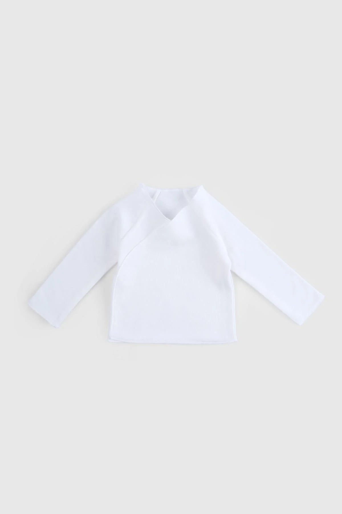 White kimono-style top from the Organic Cotton Lion Newborn Set, soft and breathable for delicate baby skin.