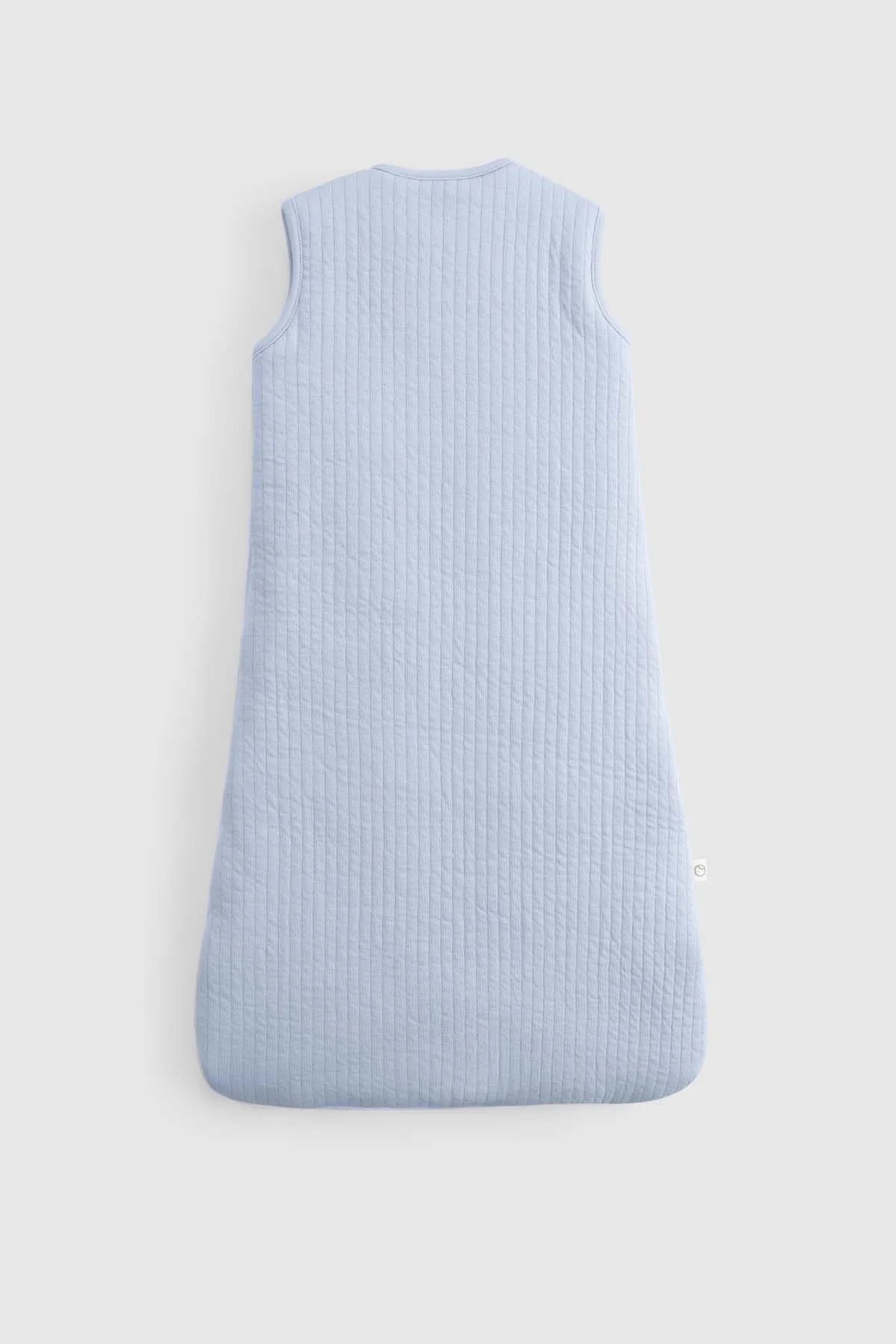 Organic cotton quilted sleeping bag in soft blue, designed for babies' comfort and safe sleep.