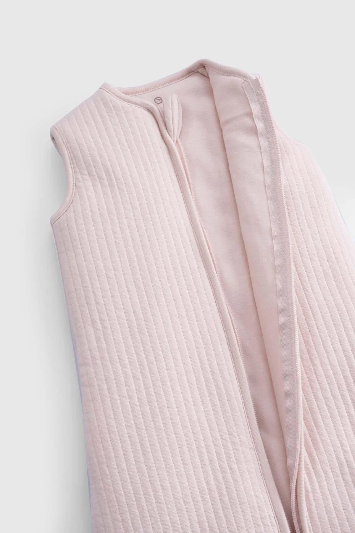 Organic cotton quilted sleeping bag in pink, featuring a sleeveless design and soft padding for baby comfort.