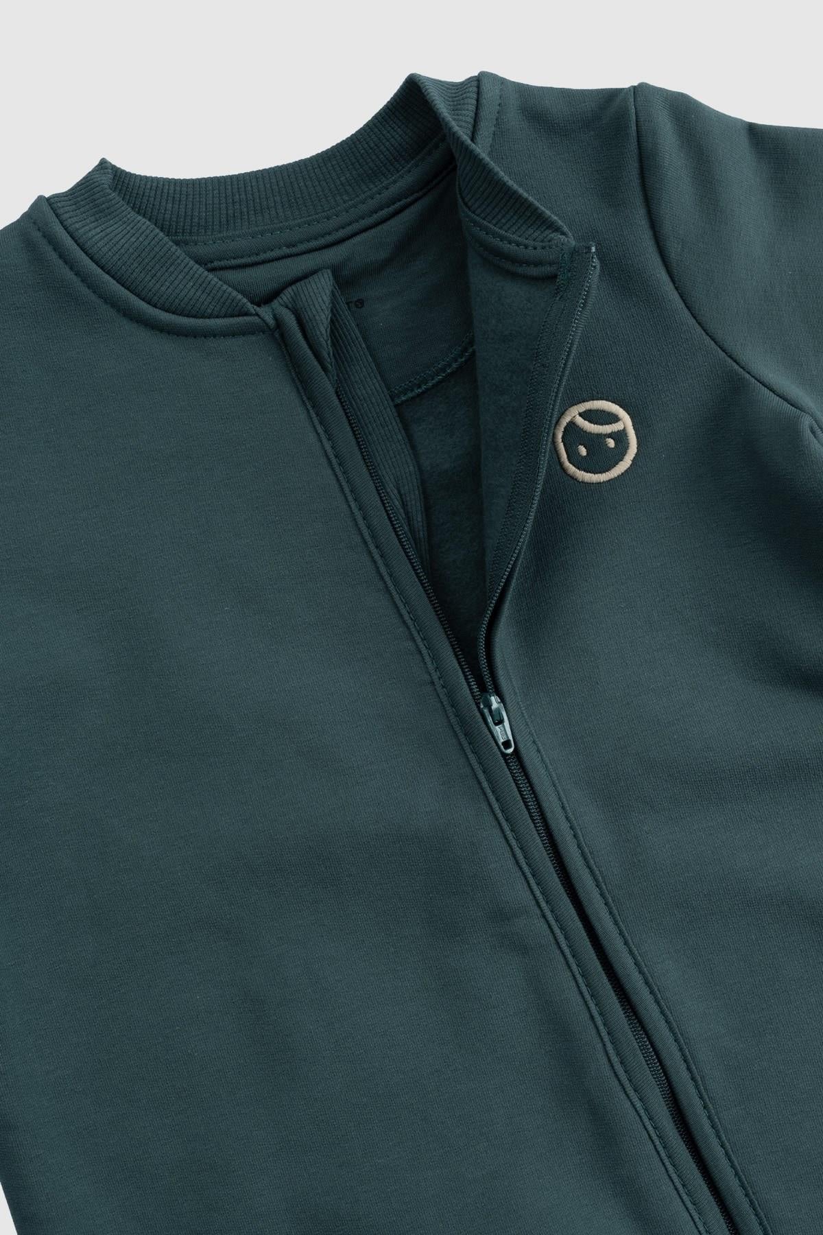 Organic cotton zipped onesie in green, featuring a cozy design with built-in mittens and booties for baby comfort.