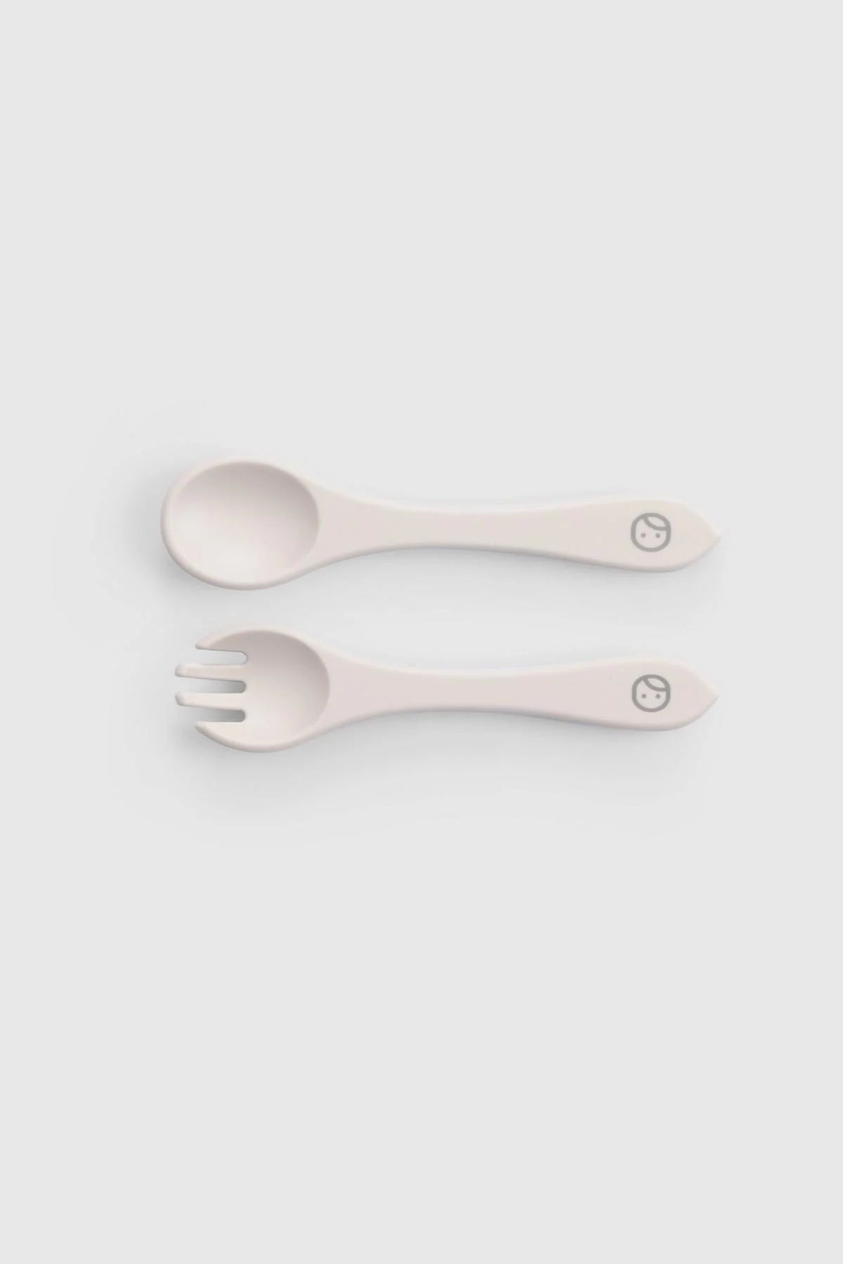 Silicone vacuum cutlery set featuring a spoon and fork in beige for easy self-feeding during mealtime.