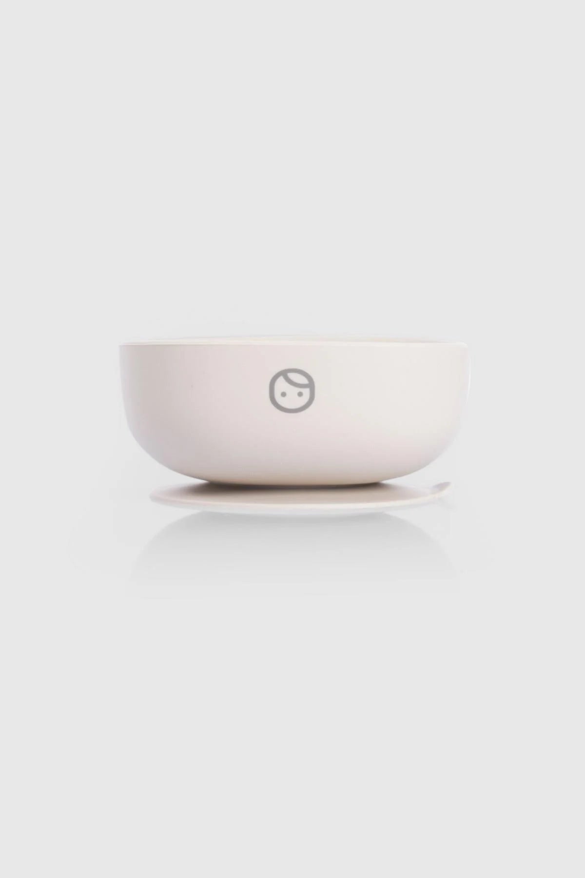 Silicone vacuum food plate in beige with logo, designed for easy self-feeding and minimal spills during mealtime.