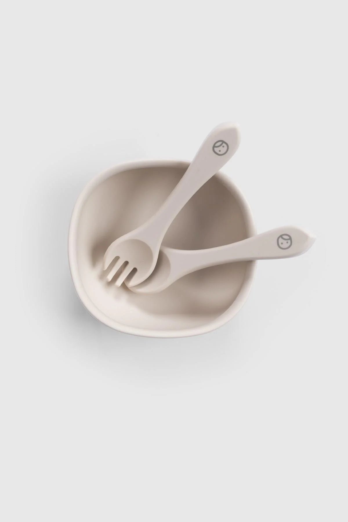Little Gusto Silicone Vacuum Food Plate and Cutlery Set in Beige with fork and spoon.