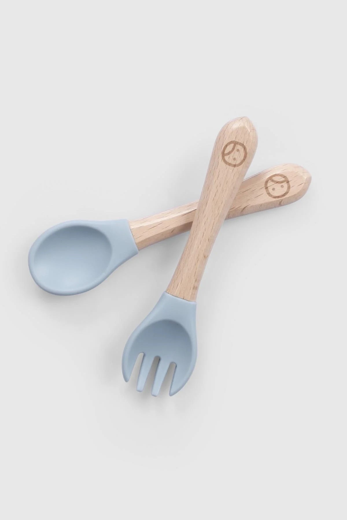 Baby cutlery set with blue silicone tips and bamboo handles for newborn self-feeding, BPA-free, Montessori-inspired.