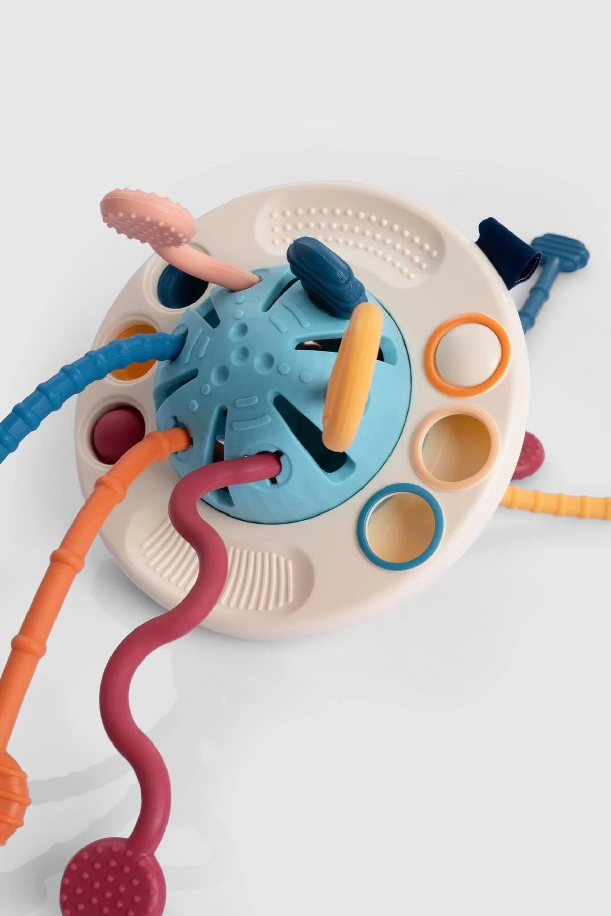Vibrant silicone educational UFO toy for toddlers, promoting hand-eye coordination and visual exploration.