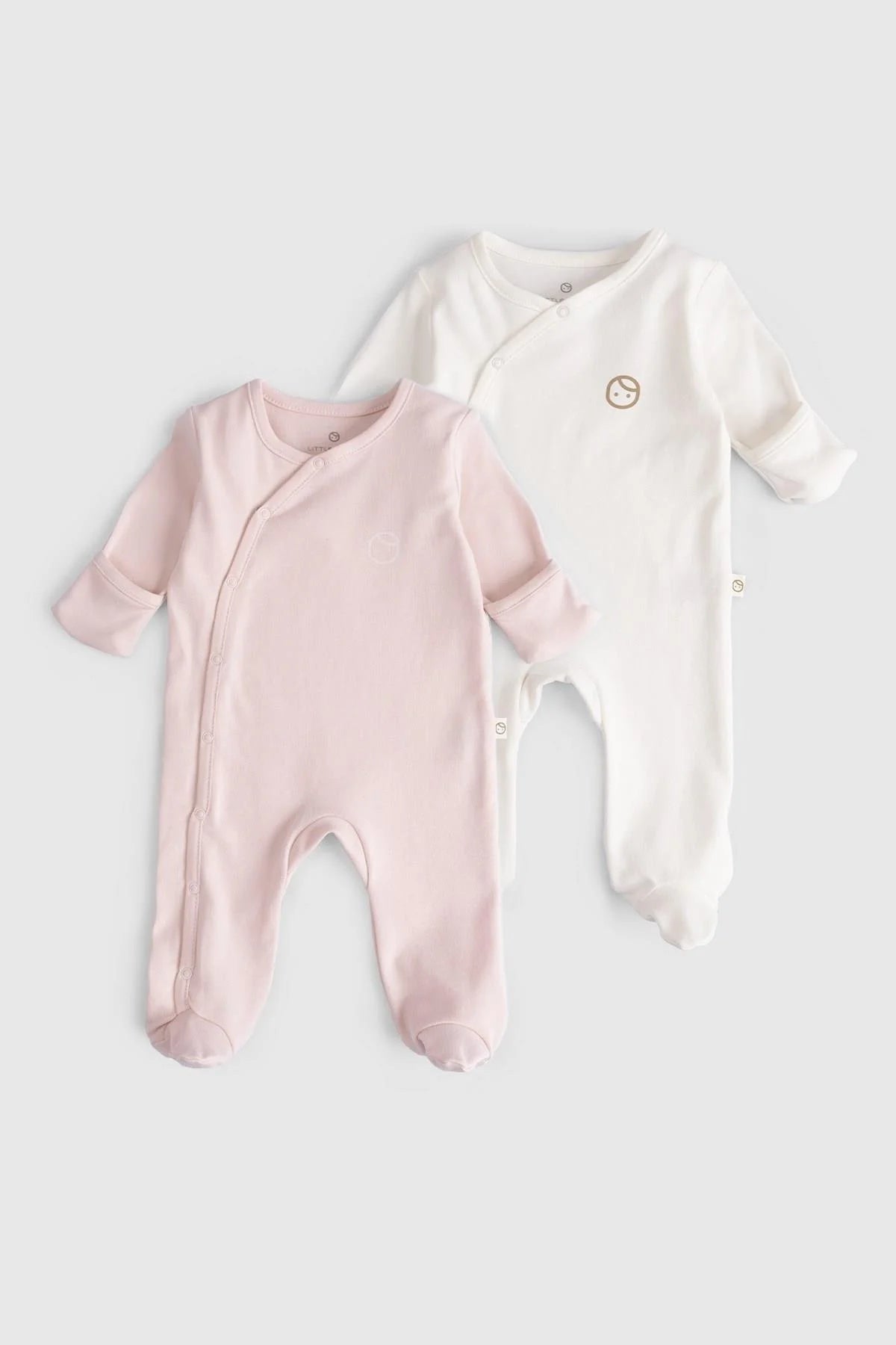 Organic cotton baby sleepsuits in pink and white, perfect for comfort and breathability, suitable for day and night use.