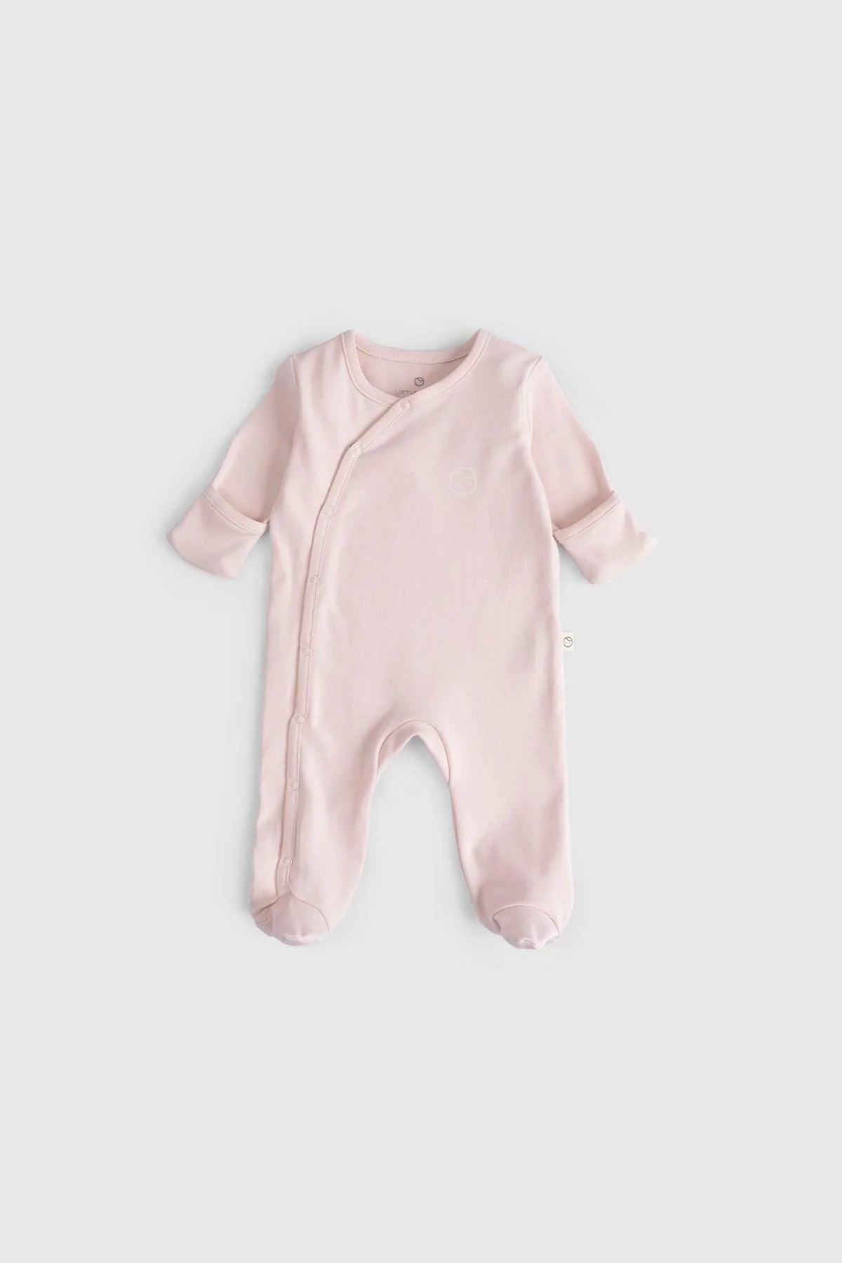 Organic cotton baby sleepsuit in soft pink, designed for comfort and breathability, ideal for infants.