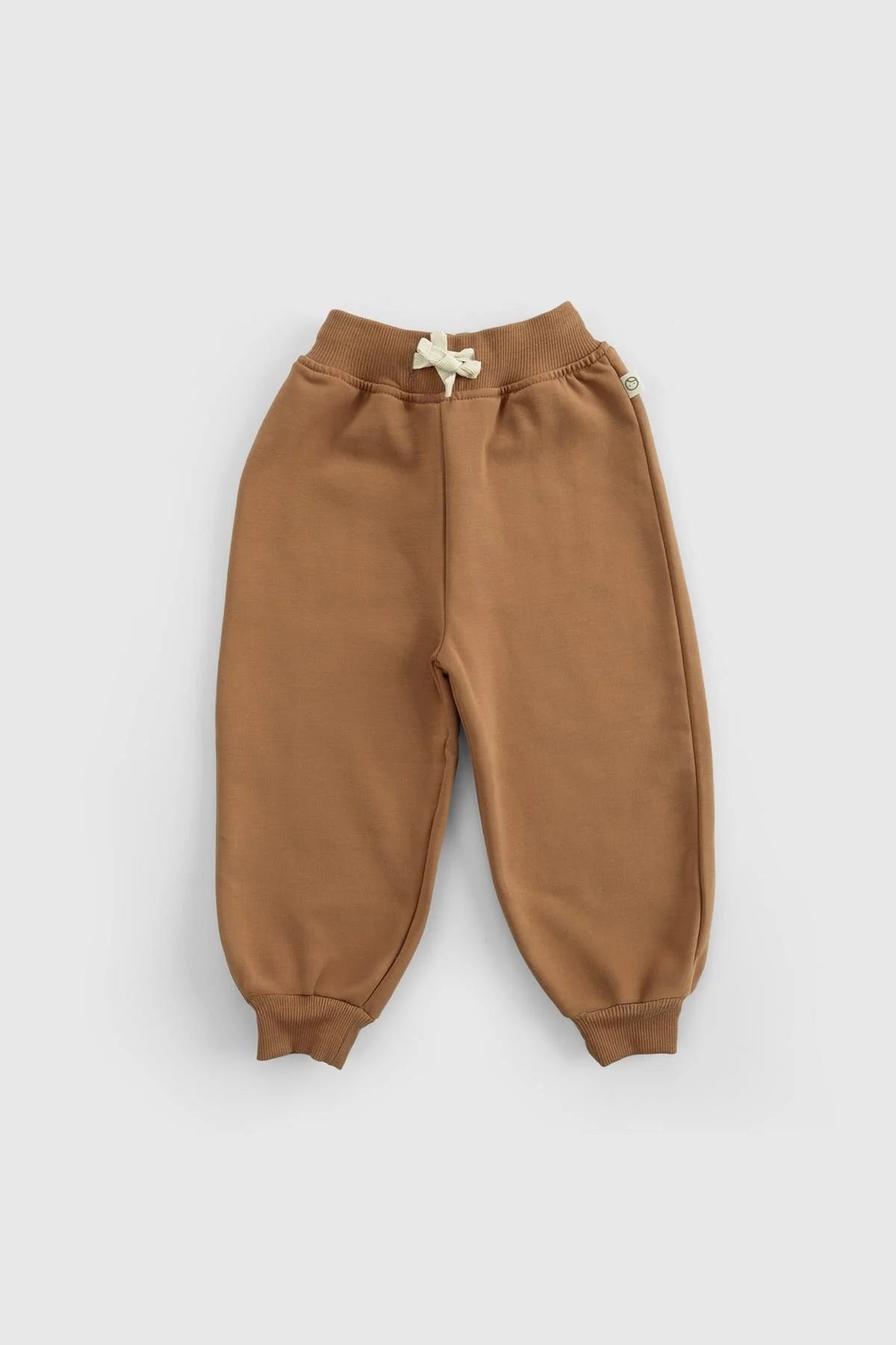 Organic cotton baby tracksuit pants in brown, featuring ribbed cuffs and adjustable waistband for comfort.