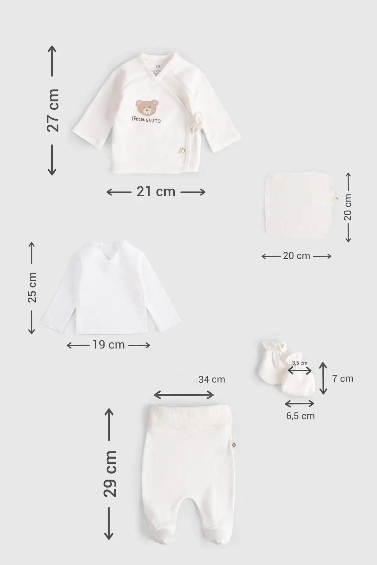 Organic cotton newborn set - 10 pieces including kimono, bodysuit, pants, booties, bib, and washcloth, all in white.