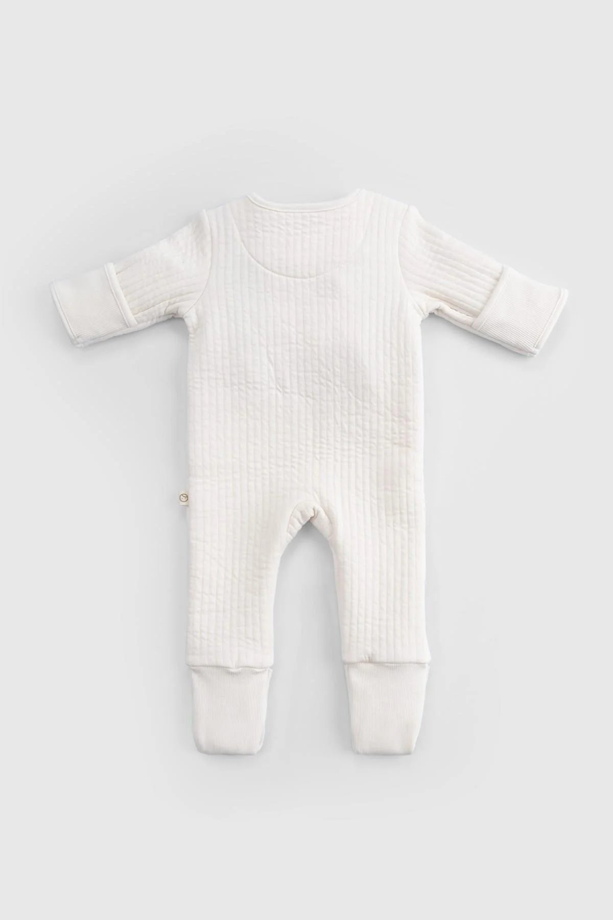 Organic cotton quilted sleepsuit in white, designed for baby comfort and warmth during cooler nights.