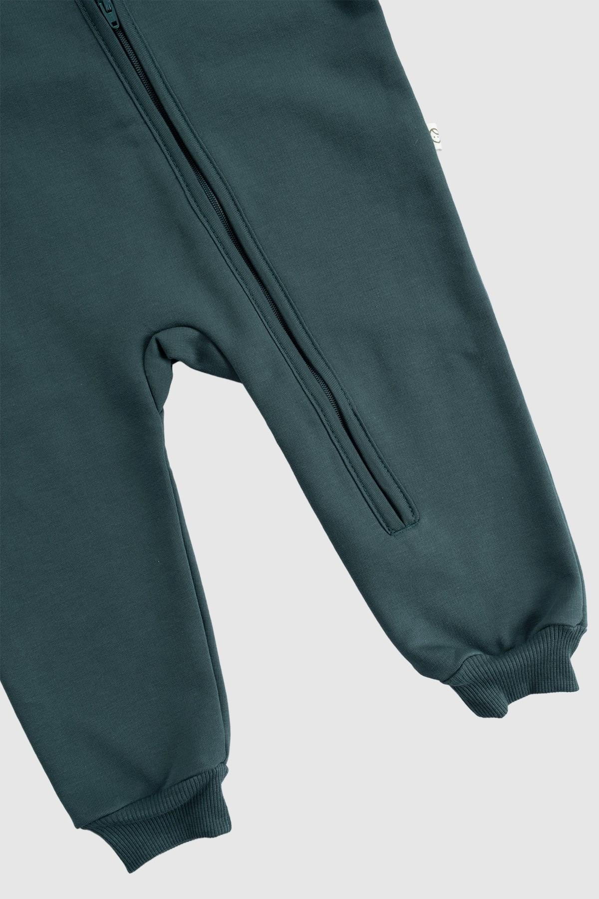 Organic cotton zipped onesie in green with quilted texture, showcasing footed design and built-in mittens for warmth.
