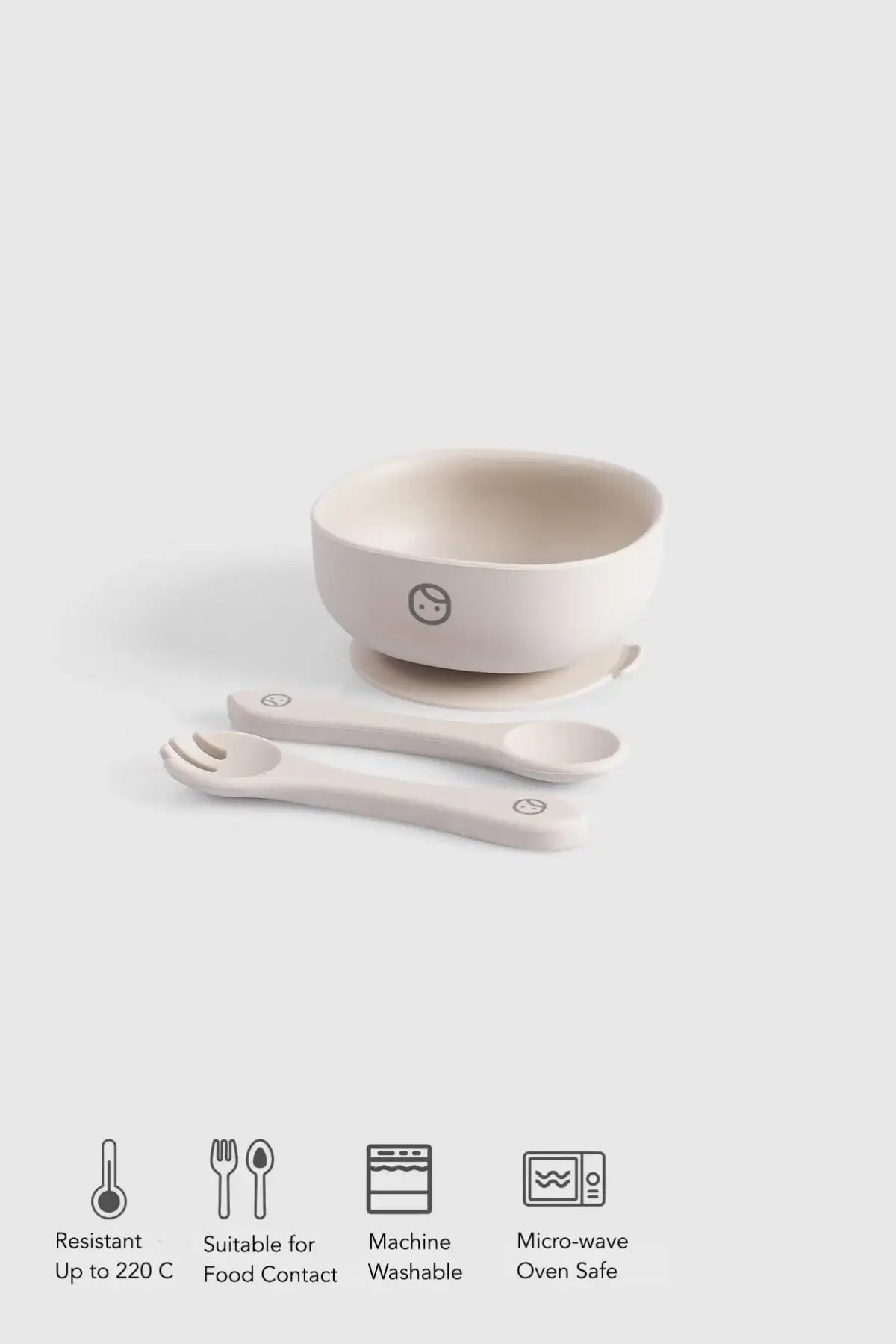 Silicone vacuum food plate and cutlery set in beige with a bowl and utensils, designed for baby self-feeding.